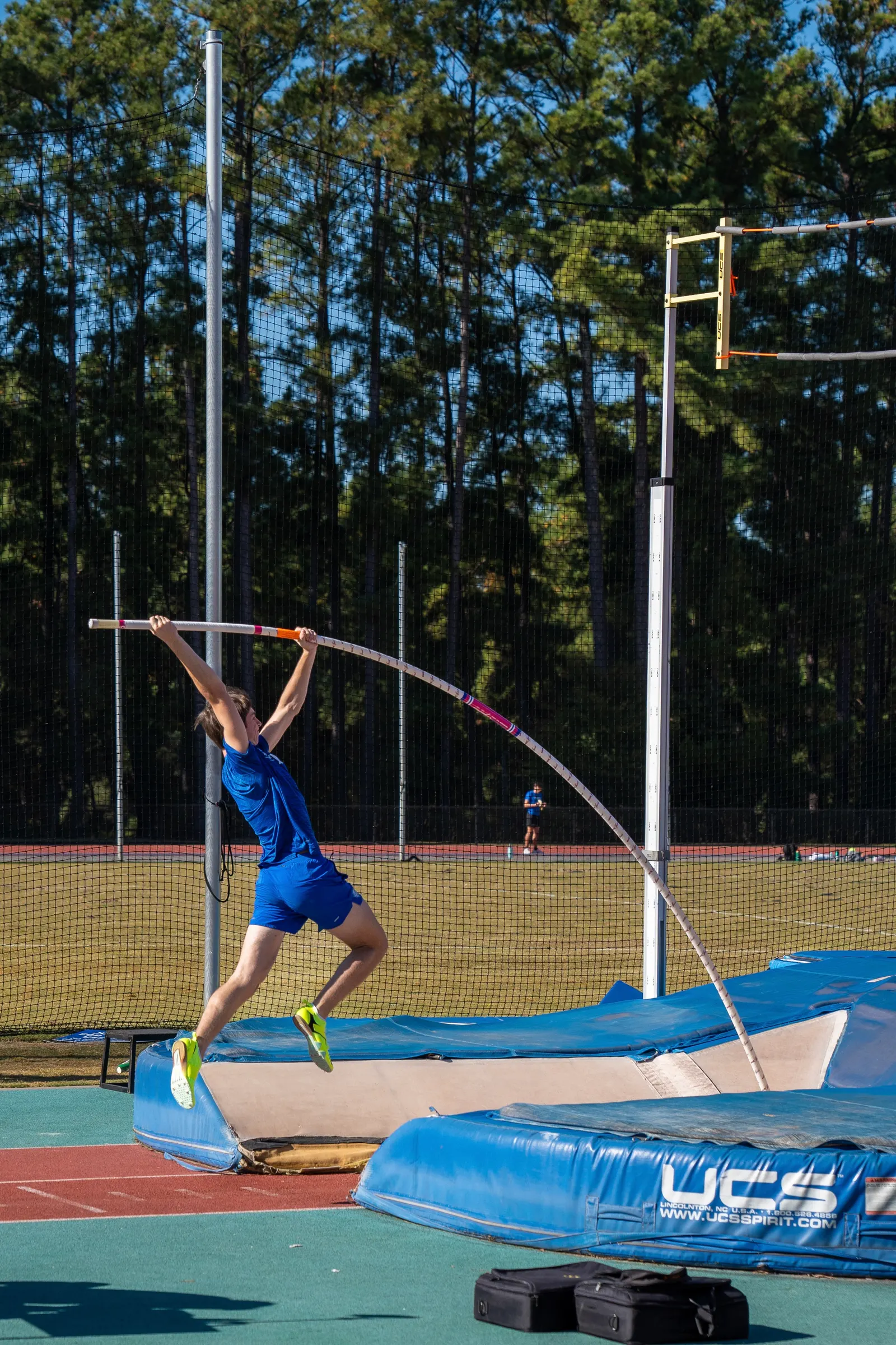 Pole vaulter planting the pole at takeoff