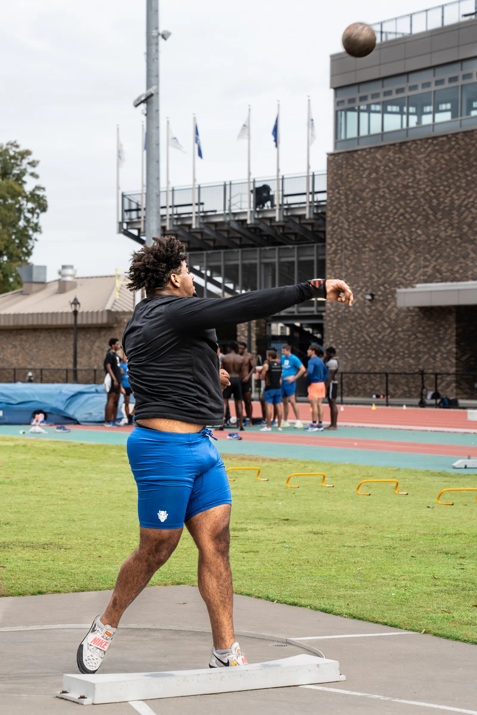 Shot putter just after release, the shot in the air